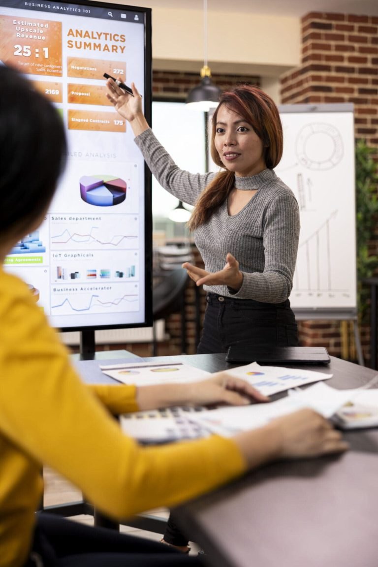 Marketing consultant presenting company growth data to a colleague