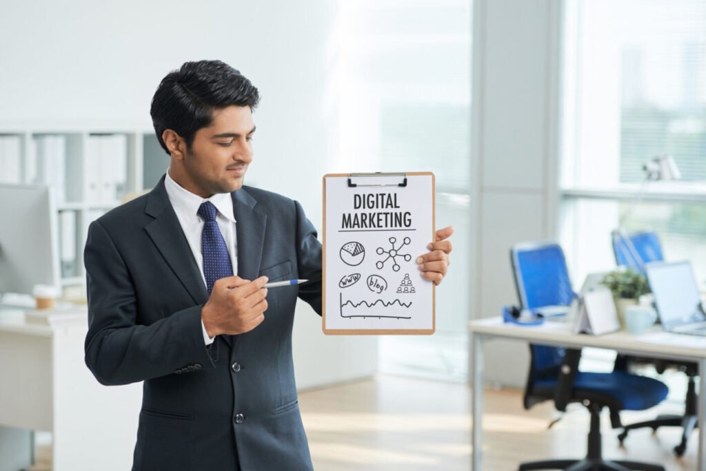 Man in a suit holding a digital marketing poster in an office