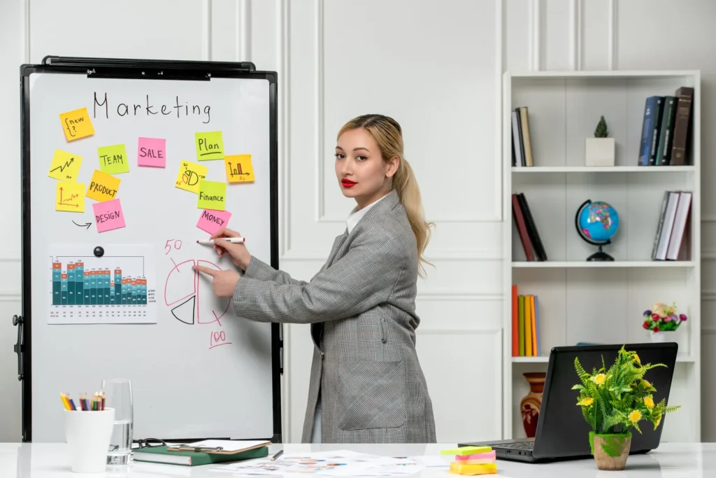Industry mentor in a grey blazer explaining a marketing idea to her team