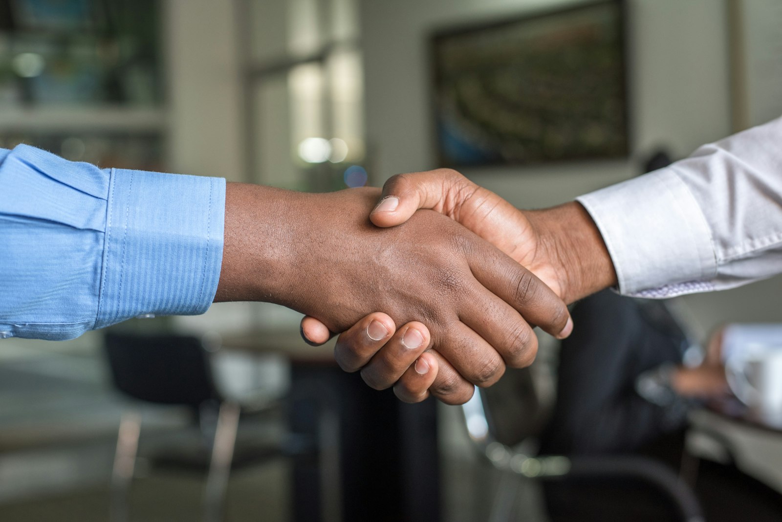 Two professionals shaking hands after a successful job interview