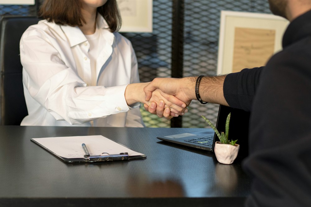 Person reviewing a printed resume at a desk